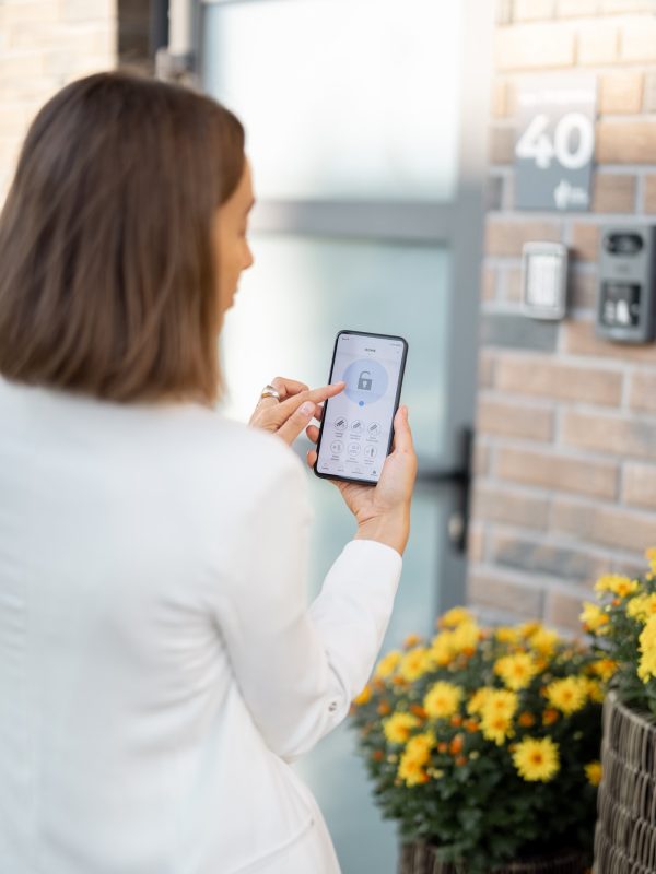 female-closes-the-door-or-turns-on-the-house-alarm-with-phone.jpg female-closes-the-door-or-turns-on-the-house-alarm-with-phone.jpg
